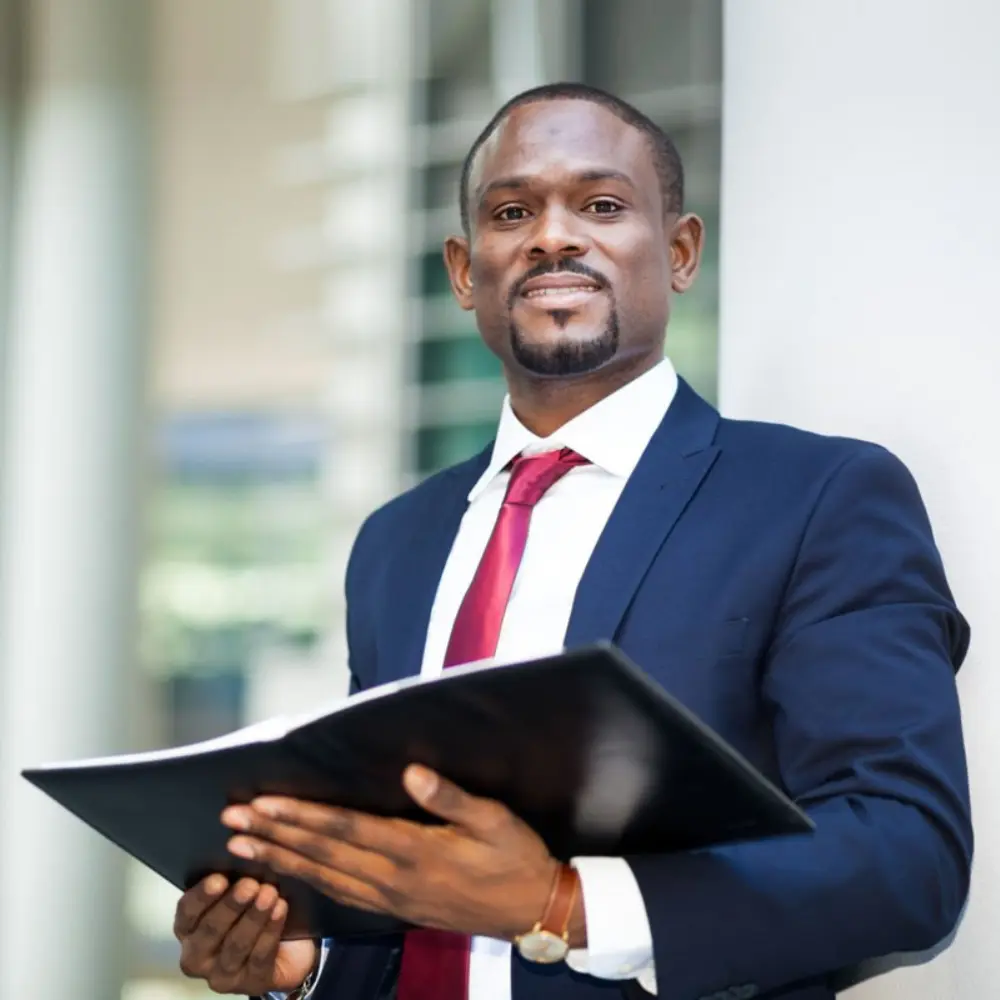 Thinking About Selling Your Insurance Agency Businessperson standing holding a file